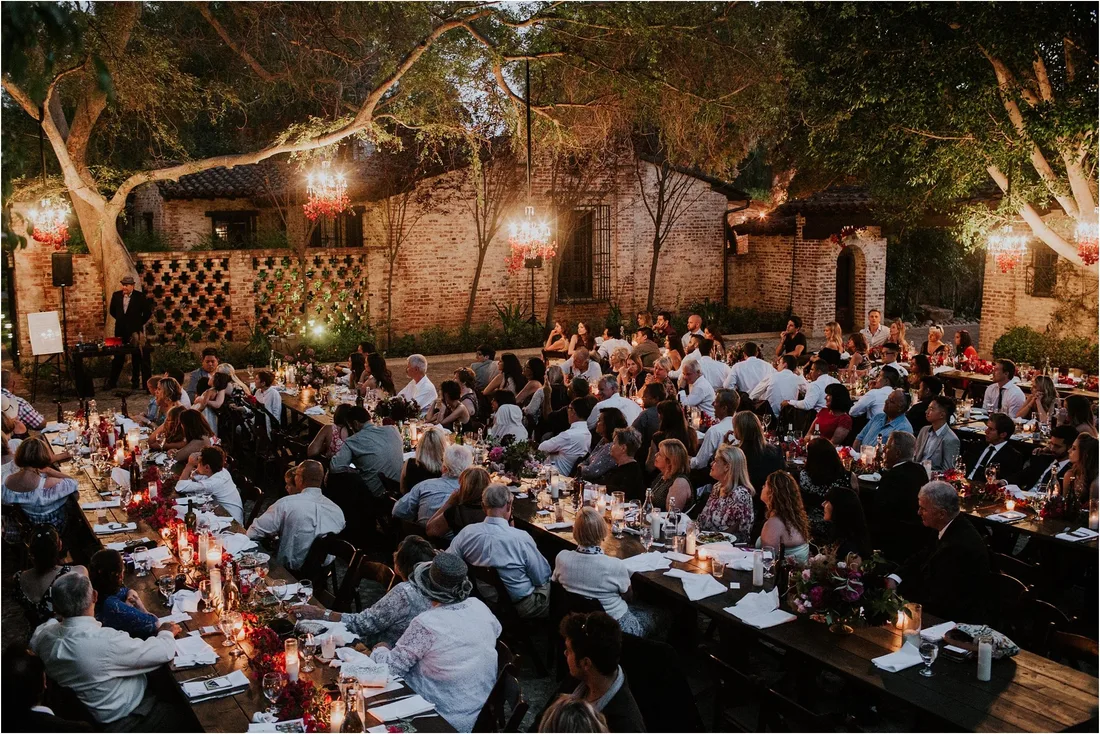 Long table reception under festoon lights after dark